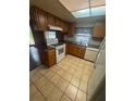 Traditional kitchen with tile flooring, wood cabinetry, and contrasting countertops at 4663 Montauk St, Orlando, FL 32808