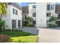 Multi-level condo building featuring well-maintained landscaping and paved driveway at 8984 Houston Pl # 103, Orlando, FL 32819