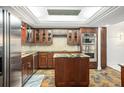 Well-appointed kitchen with custom cabinets, stainless appliances, and a functional center island at 8984 Houston Pl # 103, Orlando, FL 32819