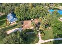 An aerial view showcases this beautiful home, lush landscaping, and an inviting lake nearby at 956 Stonewood Ln, Maitland, FL 32751