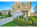 Charming two-story home featuring a well-manicured lawn and a welcoming front porch at 1093 Berry Ln, Davenport, FL 33837