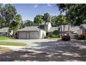 Townhome with two-car garage and a red car parked in the driveway at 543 Warrenton Rd # 543, Winter Park, FL 32792