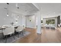 Elegant dining room with hardwood floors and modern light fixtures at 2972 Crystal Water Run, Oviedo, FL 32765