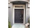 Front door with a sidelight, transom window, and gray paint at 3010 San Jacinto Cir # 3010, Sanford, FL 32771