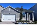 Single-story home with a two car garage, stone accents and a nicely landscaped front yard at 1173 Basalt Ln, Sanford, FL 32771
