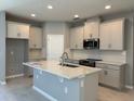 Bright kitchen featuring light colored cabinets, stainless appliances, and quartz countertops at 1173 Basalt Ln, Sanford, FL 32771