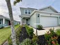 Two-story house with a two-car garage and landscaped lawn at 2227 Lovely Ln, Davenport, FL 33896