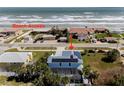 Aerial view of house near beach, highlighting its proximity to the ocean at 4260 S Atlantic Ave, Port Orange, FL 32127