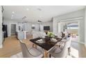 Open-concept dining room with stylish table, chairs, and sliding glass doors leading to the backyard at 13882 Sw 56Th Ln, Ocala, FL 34482