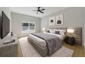 Serene main bedroom featuring a large window, decorative art, and an upholstered headboard at 13882 Sw 56Th Ln, Ocala, FL 34482