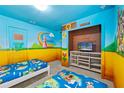 Themed bedroom with twin beds, Mario murals, and TV at 1473 Moon Valley Dr, Davenport, FL 33896