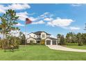 Inviting two-story home with manicured lawn and a flag, featuring stone and siding exterior at 4001 Ainsley Ave, Orlando, FL 32833
