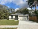 Charming single-story home featuring a two-car garage, freshly painted exterior, and newly installed driveway at 114 Redding St, Davenport, FL 33837