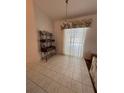 Dining room with wood table and access to backyard at 1833 Queen Palm Dr, Apopka, FL 32712