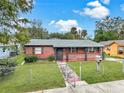 Single-story brick home with fenced yard, quaint walkway, and inviting curb appeal in a serene neighborhood at 1904 Historic Goldsboro Blvd, Sanford, FL 32771