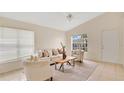Bright living room features neutral décor, tile flooring, and vaulted ceilings at 1957 Teaberry Ct, Orlando, FL 32824