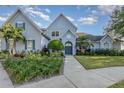 Charming home with lush landscaping, mature palms, and a welcoming facade at 2523 Madron Ct, Orlando, FL 32806