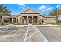 Beautiful clubhouse exterior featuring stone accents, a covered entryway, and accessible parking at 314 Rover Rd, Ormond Beach, FL 32174