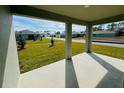 Covered patio with a view of the manicured lawn and neighborhood at 314 Rover Rd, Ormond Beach, FL 32174