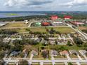 Aerial view of property with nearby shopping and Lake Minneola in the background at 721 Willow Run St, Minneola, FL 34715