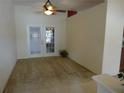 View of living room featuring double glass doors that lead to a patio at 721 Willow Run St, Minneola, FL 34715