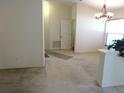 Bright living room featuring neutral walls, carpeted flooring, and open entry to other rooms at 721 Willow Run St, Minneola, FL 34715