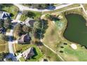 Aerial view showing property lines, mature trees, proximity to green space, pond and golf course at 36711 Alaqua Ct, Eustis, FL 32736