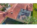 High aerial shot of the villa featuring tile roof, an enclosed lanai, and mature landscaping at 4916 Fiji Cir # 11, Orlando, FL 32808