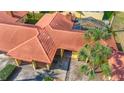 A high aerial shot of the villa with tile roof, screened-in patio, and mature landscaping at 4916 Fiji Cir # 11, Orlando, FL 32808