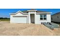 New home construction showing a two-car garage and freshly installed windows at 3106 Windswept, Wildwood, FL 34785