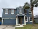 Two-story home with an attached two-car garage and well-maintained lawn at 3612 Julius Estates Blvd, Winter Haven, FL 33881