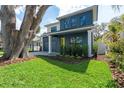 Beautiful two-story home with a large tree in the front yard and well-maintained landscaping at 1904 Illinois St, Orlando, FL 32803
