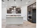 Modern kitchen with dark cabinets, marble countertops, and stainless steel appliances at 1325 Arklow Cir, Ormond Beach, FL 32174