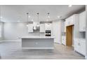 Modern kitchen with white cabinets, stainless steel appliances, and large island at 2944 Arranmore Dr, Ormond Beach, FL 32174