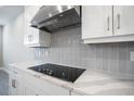 Close up of kitchen's cooktop and white cabinets at 2944 Arranmore Dr, Ormond Beach, FL 32174