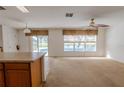 Bright Gathering room features carpeting, ceiling fan, and view of the pool at 1513 Blue Sky Way, Clermont, FL 34714