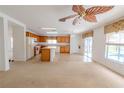 Kitchen boasts wood cabinets, an island, and tile flooring at 1513 Blue Sky Way, Clermont, FL 34714