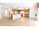 Open kitchen with light wood cabinets and an island at 1513 Blue Sky Way, Clermont, FL 34714