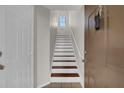 Bright staircase featuring white risers and wood treads at 6107 Metrowest Blvd # 104, Orlando, FL 32835