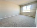 Spacious bedroom features neutral carpet, a large window for natural light, and blank walls at 5286 Teirgarten St, Saint Cloud, FL 34771