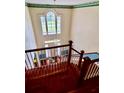 View from the staircase to the front entrance of the home and its large window at 211 River Bluff Dr, Ormond Beach, FL 32174