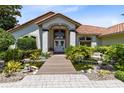 Charming front entrance with a koi pond, stepping stones, and lush landscaping at 4024 W Danby Ct, Winter Springs, FL 32708