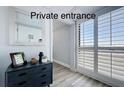 Inviting entryway featuring modern decor, sleek furniture, and white shuttered doors for a bright and airy feel at 6165 Carrier Dr # 2602, Orlando, FL 32819