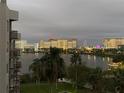 Stunning night view overlooking a calm lake with illuminated buildings and vibrant amusement park lights at 6165 Carrier Dr # 2602, Orlando, FL 32819