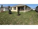 Grassy backyard with partial view of home at 308 Barebow Ln, Ormond Beach, FL 32174