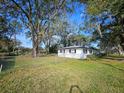 Fenced side yard with mature trees and chain link fence at 5528 Flamingo Ave, Lakeland, FL 33809