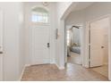 Bright entryway with tiled floors and view of bedroom at 8169 Fan Palm Way, Kissimmee, FL 34747