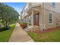 Townhome exterior showcasing architectural details and landscaping at 207 Maplebrook Dr, Altamonte Springs, FL 32714