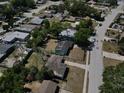 An aerial shot showcasing the neighborhood, with well-spaced homes and tree-lined streets in a residential area at 5018 Figwood Ln, Orlando, FL 32808
