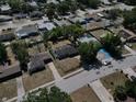 An aerial shot showcasing the neighborhood, with well-spaced homes and tree-lined streets in a residential area at 5018 Figwood Ln, Orlando, FL 32808